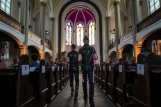 Guests, fully clothed in leather, take their seats at the 'Classic meets Fetish' concert at the Twelve Apostles Church (Zwoelf-Apostel-Kirche) in Berlin on September 9, 2021.