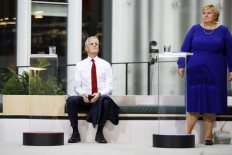 Norway's Labor Party leader Jonas Gahr Støre (L) and Norway's Prime Minister and leader of the conservative Hoyre party, Erna Solberg look on ahead of a televised debate at Deichman Library in Oslo on September 8, 2021, days ahead of the country's parliamentary elections on September 13. 