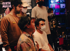 Singer-songwriter Sal Priadi (right) monitors the shooting of his single's short film directed by Aco Tenri (center), starring Sal himself and stand-up comedian Ryan Adriandhy (left). 