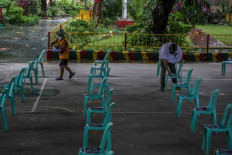In this photo taken on September 8, 2021, a teacher (right) and volunteer sort distance learning materials to be picked up by parents at a school in Quezon City, suburban Manila, ahead of another school year of remote lessons in the country due to the pandemic. Classrooms in the Philippines were silent on September 13, 2021 as millions of school children hunkered down at home for a second year of remote lessons that experts fear will worsen an educational 