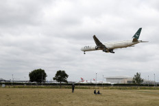 A Pakistan International Airlines Boeing 777 comes in to land at Heathrow airport in west London as the UK government's planned 14-day quarantine for international arrivals to limit the spread of Covid-19 starts on June 8, 2020.
