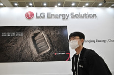 A visitor walks past a booth of LG Energy Solution during the 2021InterBattery exhibition at COEX in Seoul on June 11. The Korean company wants to mass-produce NCMA battery cells in West Java. 