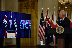 United States President Joe Biden watches as Australian Prime Minister Scott Morrison speaks virtually on national security at the White House in Washington, DC, on Thursday. The two nations announced a new defense alliance with the United Kingdom that has surprised many and angered China.