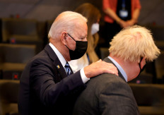  US President Joe Biden speaks with Britain's Prime Minister Boris Johnson during a plenary session at a NATO summit in Brussels, Belgium, June 14, 2021. 