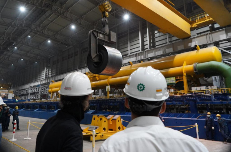 Krakatau Steel employees watch the production of the first hot rolled coil (HRC) steel on May 17, 2021, in the company's second hot steel mill in Banten. 