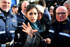 In this file photo taken on November 21, 2018 Rome mayor Virginia Raggi (C) talks with Rome municipal police officers during the demolition of eight illegally built villas seized by Rome police to the Casamonica mafia clan in the south-eastern suburb Quadraro district of Rome on November 21, 2018. Despite family members boasting in wiretapped conversations of being powerful enough to challenge Italy's historic mafias, the Casamonica were long seen as a local, if violent, criminal gang. But that all changed this week, when a Rome court classified it as a mafia association and sentenced five of its chief members to up to 30 years each, under the highly strict prison regime reserved for mobsters.
