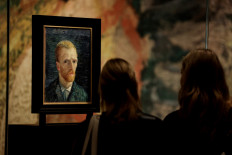 Visitors look at a self-portrait of Vincent Van Gogh at the Van Gogh Museum's in Amsterdam on September 16, 2021.