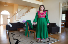 Bahar Jalali, an Afghan academic, wears an Afghan traditional dress as she speaks with AFP during an interview in her home in Glenwood, Maryland, September 24, 2021.