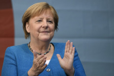 German Chancellor Angela Merkel applauds during a campaign rally for Christian Democratic Union CDU leader and chancellor candidate Armin Laschet (not pictured) in Aachen, western Germany, on September 25, 2021, one day ahead of the German federal elections.