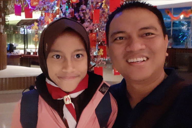 Together forever: Schoolteacher Achmad Sofyan and his daughter Fera. Achmad became a single father after his wife's death. He says her presence keeps him grounded.
(Courtesy of Achmad Sofyan)