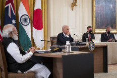 US President Joe Biden (center) and Indian Prime Minister Narendra Modi (left) listen during a Quad Leaders Summit with Australian Prime Minister Scott Morrison and Japanese Prime Minister Suga Yoshihide in the East Room of the White House on September 24, 2021 in Washington, DC. The four leaders are expected to discuss a range of topics including climate change, Covid-19 vaccines and a free and open Indo-Pacific ocean region. 