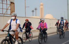 A picture taken September 17, 2021 shows Saudi and foreign women, part of a mixed-gender cycling club, cycling in the Red Sea city of Jeddah.