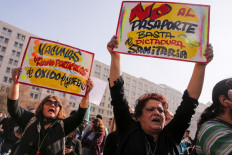 People holding signals that read 