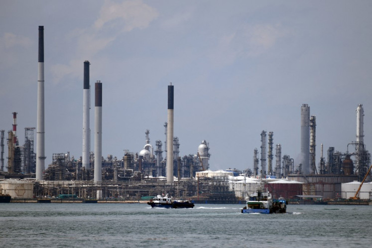 Boats sail past the Shell refinery on Pulau Bukom off Singapore on Nov. 11, 2020. The price of Brent crude oil jumped on Sept. 28, 2021 above 80 USD for the first time in almost three years on expectations for surging demand and concerns about supplies.