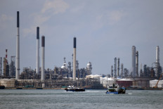 Boats sail past the Shell refinery on Pulau Bukom off Singapore on Nov. 11, 2020. The price of Brent crude oil jumped on Sept. 28, 2021 above $80 for the first time in almost three years on expectations for surging demand and concerns about supplies.
