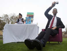 Chandra Bahadur Dangi, from Nepal, (left) the shortest adult to have ever been verified by Guinness World Records, poses for pictures with the world's tallest man Sultan Kosen from Turkey, during a photocall in London on November 13, 2014, to mark Guinness World Records Day. Chandra Dangi, measures a tiny 21.5in (0.54m) – the same height as six stacked cans of beans. Sultan Kosen measures 8 ft 3in (2.51m). 