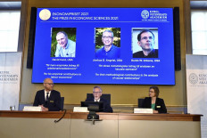 Goran K. Hansson (center), Permanent Secretary of the Royal Swedish Academy of Sciences, and Nobel Economics Prize committee members Peter Fredriksson (left) and Eva Mork (right) give a press conference to announce the winners of the 2021 Sveriges Riksbank Prize in Economic Sciences in Memory of Alfred Nobel at the Royal Swedish Academy of Sciences in Stockholm, on October 11, 2021. Canadian David Card, Israeli-American Joshua Angrist and Dutch-American Guido Imbens won the Nobel Economics Prize for insights into the labour market and 
