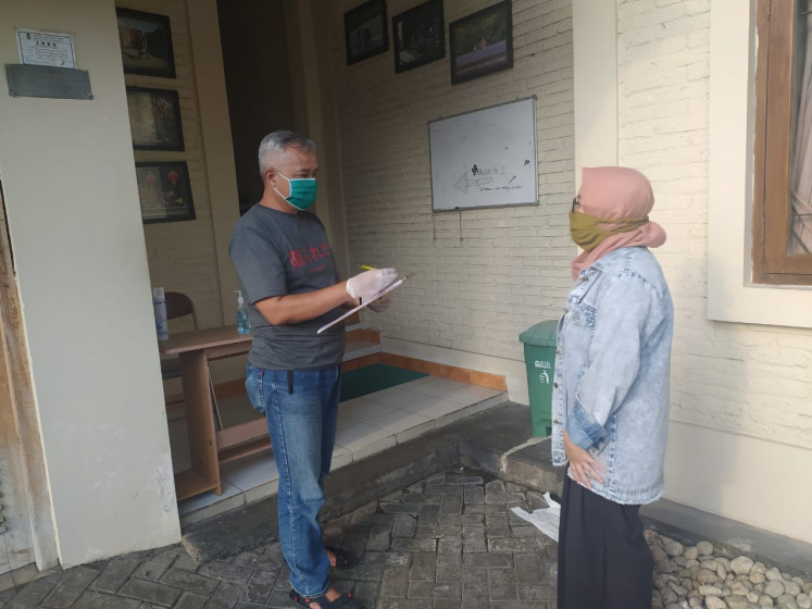 Empathy: A Rifka Annisa Women's Crisis Center staff member takes down the details of a woman seeking refuge. (Rifka Annisa Women's Crisis Centre)
