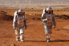 A couple of astronauts from a team from Europe and Israel walk in spacesuits during a training mission for planet Mars at a site that simulates an off-site station at the Ramon Crater in Mitzpe Ramon in Israel's southern Negev desert on October 10, 2021. Six astronauts from Portugal, Spain, Germany, the Netherlands, Austria, and Israel will be cut off from the world for a month, from October 4-31, only able leave their habitat in spacesuits as if they were on Mars. Their mission, the AMADEE-20 Mars simulation, will be carried out in a Martian terrestrial analog and directed by a dedicated Mission Support Center in Austria, to conduct experiments ahead of future human and robotic Mars exploration missions.