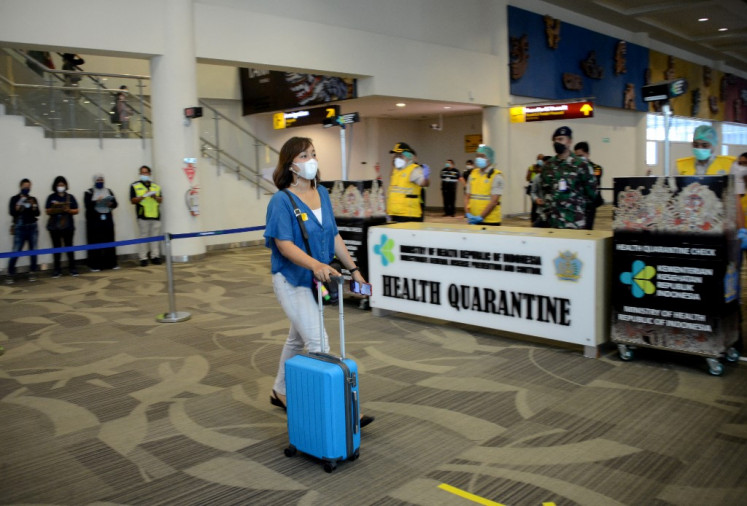 A woman takes part in a simulation of Covid-19 health protocols at the international airport in Tuban on Indonesia's resort island of Bali on October 9, 2021, ahead of the island reopening to tourists on October 14. 