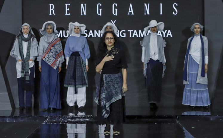 Struggling: Riri Rengganis (center) poses with models after a recent fashion show. (Riri Rengganis)