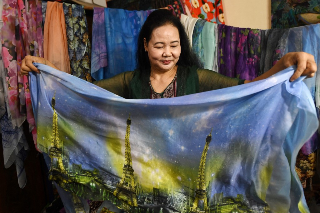 Binh Danh enthusiastically tossing colorful leaves into the air