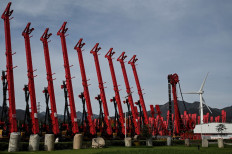 Cranes made by Chinese heavy equipment manufacturing company Sany are seen at a factory in Beijing on Oct. 15, 2021. China's economic growth weakened more than expected in the third quarter 