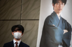 This picture taken on October 7, 2021 shows Japan's professional shogi player Sota Fujii posing for a photo call during a press conference of a competition between Masayuki Toyoshima, in Tokyo.