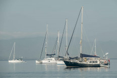 Boats are moored along Bali's Lovina Beach on July 3, 2020.