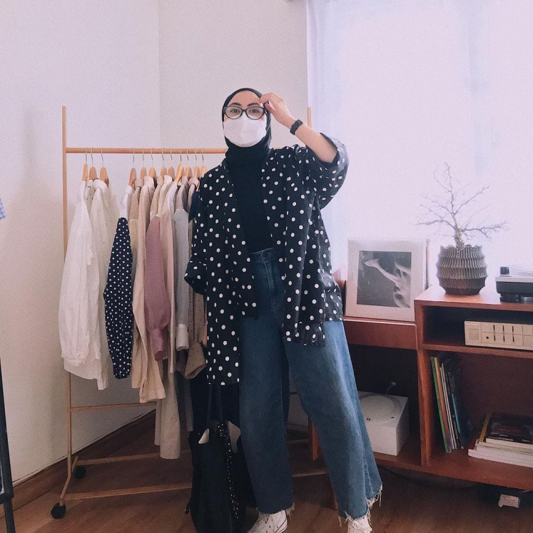 Iconic pattern: Via Rini Anggraeni, who founded Teman Thrifty, poses in a jacket made from polka-dot fabric, which has become the 