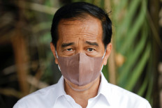 President Joko Widodo wears a protective mask during an interview on Oct. 19, 2021 in Bebatu, a remote area near Tarakan, North Kalimantan. 