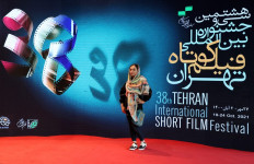 An Iranian arrives for the opening day of the 38th Tehran International Short Film Festival (TISFF) in the Iranian capital on October 19, 2021.