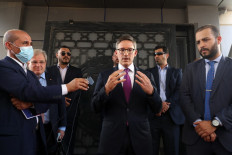 US envoy Derek Chollet (center) speaks to the media as US Ambassador to Libya Richard Norland (2-left) looks on, in the capital Tripoli, on September 15, 2021. Less than a year since a landmark ceasefire, war-torn Libya is preparing for elections, but controversy over a voting law governing the country's presidential elections poses a new threat to the UN-led peace process. 