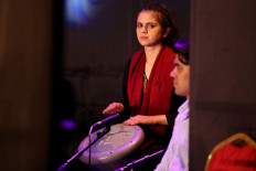 Shogofa Safi, percussionist and conductor of the Zohra orchestra, plays along with other members of the Afghan music community who escaped to Qatar, during a concert in the Qatari capital Doha on October 18, 2021.