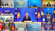 This handout photo released by the host broadcast, ASEAN Summit 2021, on October 27, 2021 shows Australian Prime Minister Scott Morrison (C) taking part in the ASEAN-Australia Summit on the sidelines of the 2021 Association of Southeast Asian Nations (ASEAN) summit, held online on a live video conference in Brunei's capital Bandar Seri Begawan. 