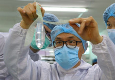 Founder and inventor of Wondaleaf Unisex Condom John Tang Ing Ching inspects the unisex condom at his factory in Sibu, Malaysia October 19, 2021. 