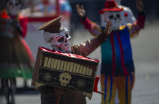 People take part in the Day of the Dead parade at Zocalo Square in Mexico City on October 31, 2021.
