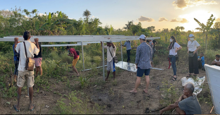 Jakarta Intercultural School students, members of Solar Chapter and residents of Fatoin village in East Nusa Tenggara work together to install metal frames for solar panels.