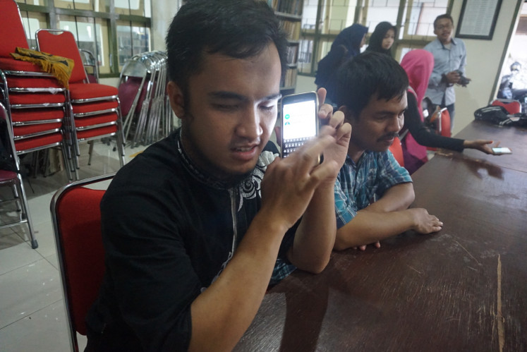 Story time: A visually impaired member of Braille’iant Indonesia listens to an audiobook made by sighted volunteers. (Courtesy of Braille’iant Indonesia)
