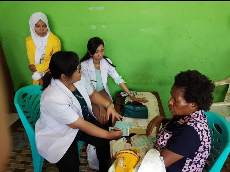 Passionate about helping: Dr. Nidya Ayomi (on the left, with glasses) while serving as a general practitioner in Wondama Bay. (Courtesy of Nidya Ayomi's family)