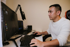 Afghan Hafiz Afzali, 34, sits in front of a computer screen at his home and models 3d characheters for his Youtube videos, on October 15, 2021 in Espoo, Finland.