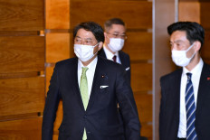 Yoshimasa Hayashi (left), named to become Japan's new foreign minister, leaves the prime minister's office in Tokyo on November 10, 2021.
