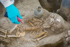 Handout picture released by Peruvian Ministry of Culture shows people working at the archaeological complex of Chan Chan following the discovery of a tomb with 25 human remains, in Trujillo, Peru on November 11, 2021. The remains found are mostly women of not more than 30 years, who have objects dedicated to textile activities, a couple of infants, a couple of adolescents, and about 70 vessels. According to Jorge Meneses Bartra, responsible for the archaeological research project, it's a very specific population sample.
