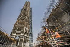  In this file photo taken on August 03, 2021 shows a view of the 'Iconic Tower' skyscraper under construction (expected to reach an elevation of 1000 metres) at Egypt's 'New Administrative Capital' megaproject, some 45 kilometres east of Cairo. This crowning jewel of President Abdel Fattah al-Sisi's grand urban plans was set to be unveiled on June 30 this year, the anniversary of mass protests, backed by the military, against the divisive rule of late Islamist president Mohamed Morsi in 2013. But the launch was postponed because of the coronavirus pandemic that led to a downturn in the market. 