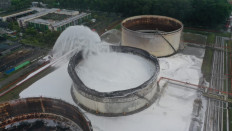 A tank at Pertamina's Cilacap oil refinery in Central Java is sprayed with fire retardant on Saturday. Pertamina announced on Sunday that the fire had been extinguished.
