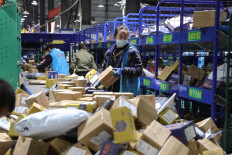Workers sort packages at a logistics company in Hengyang, Hunan, China, on Nov. 12, 2021, a day after Singles’ Day, the biggest shopping day of the year.