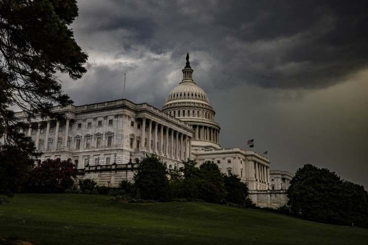 Storm clouds hang above the US Capitol Building after a heavy thunderstorm blew through the area on Capitol Hill on July 26, 2021 in Washington, DC.