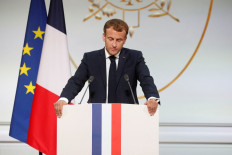 French president Emmanuel Macron delivers a speech during a ceremony in memory of the Harkis, Algerians who helped the French Army in the Algerian War of Independence, at the Elysee Palace in Paris, on September 20, 2021. 