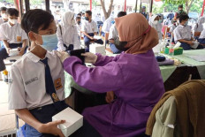Accelerated jab: A student of SMP 1 Karawang Junior High School is given a COVID-19 vaccine dose. The government received three batches of Pfizer vaccines from Saturday to Monday. 