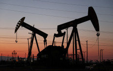 The sun sets beyond pumpjacks in the Belridge oil field near McKittrick, California, US, on Nov. 03, 2021. Asian markets fell Wednesday as high oil prices stoke inflation fears around the globe.